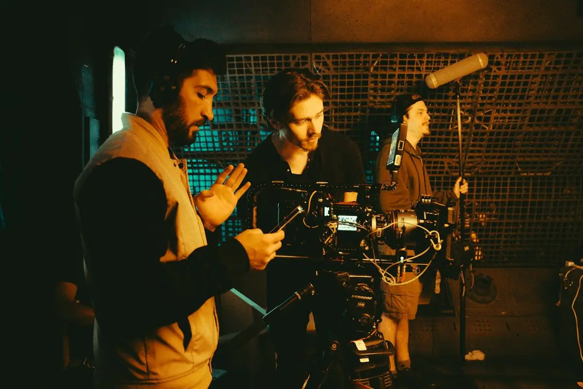 A small crew gathered round a camera and a boom microphone
