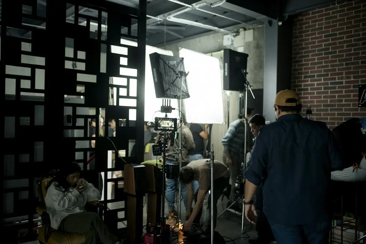A crew preparing a lighting setup in a studio